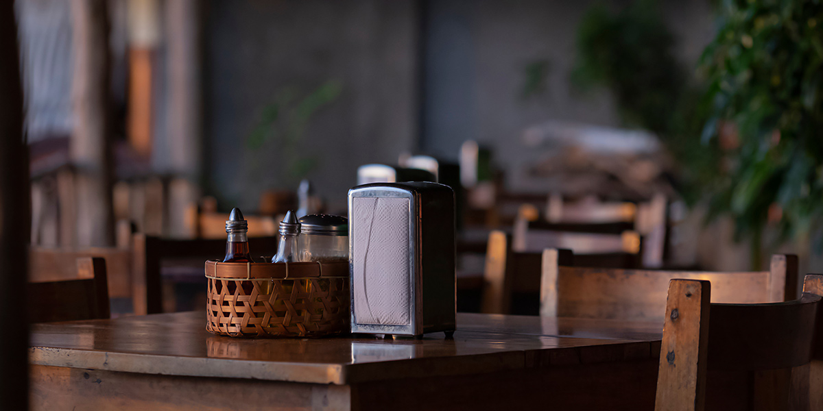 empty restaurant tables in dim lighting