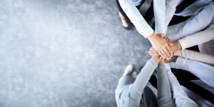 group of people putting their hands together